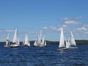 15 sailboats racing on Great Pond